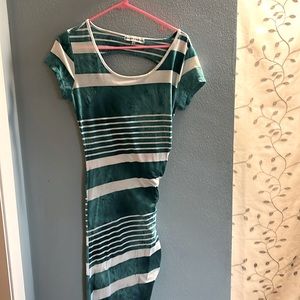 Fitting dress with left sided slit to mid thigh